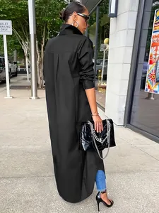 A detailed view of an oversized black long-sleeve shirt in a stylish urban setting