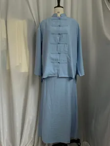 Detailed view of light blue linen-like New Chinese style shirt and skirt set on mannequin.
