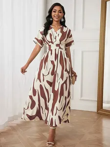 Full-body view of a brown abstract print maxi dress with a cinched waist.