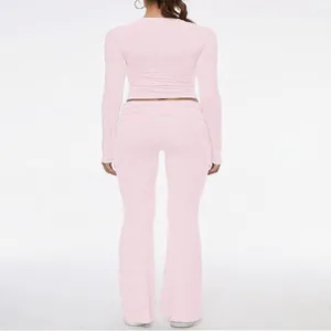 Detailed back view of a light pink long sleeve crop top and low waist flare pants set