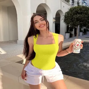 Outdoor fashion shot of a bright yellow U-neck ribbed sleeveless bodysuit for women