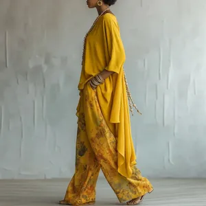 Elegant woman wearing a mustard yellow top and floral wide-leg pants casual outfit set