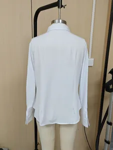 Detailed back view of a professional white slim-fit long-sleeved shirt shown on a mannequin