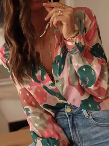 Detail view of women's long sleeve button-down shirt with elegant gold foil leaf print