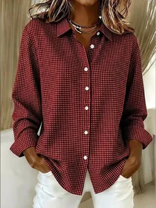 Detailed view of women's red and black gingham long-sleeved shirt with lapel collar
