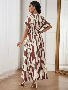 Elegant abstract print maxi dress shown from the back featuring a smocked waist.