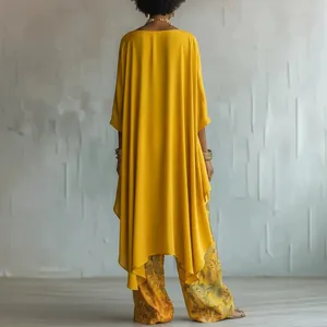 Back view of elegant mustard yellow oversized tunic paired with floral print wide-leg trousers