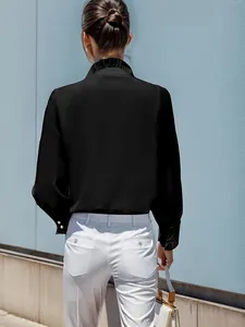 Rear view of an elegant black long sleeve shirt featuring a ruffled collar design