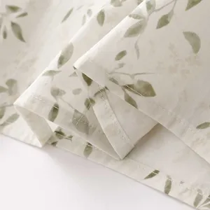 Detailed view of women's floral print shirt with fine stitching and soft linen texture