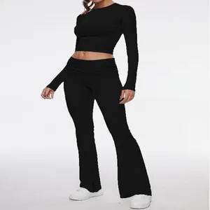 Women's black 2-piece set featuring long sleeve crop top and low waist flare pants