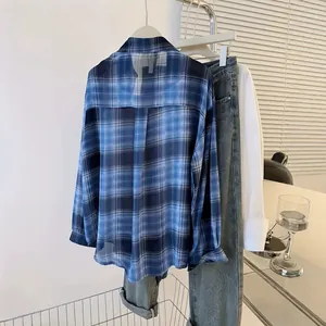 Lightweight blue plaid chiffon sun protection shirt hung on a modern clothing rack