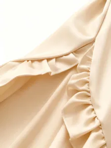 Close-up detail of elegant ruffle hem on a champagne satin casual blouse for women