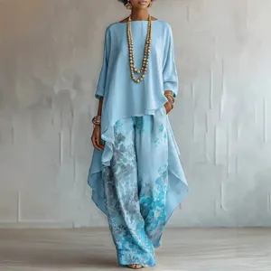 Elegant light blue long-sleeve asymmetrical tunic paired with floral print wide-leg trousers