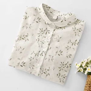 Elegant white blouse with green leaf print and Peter Pan collar for women.