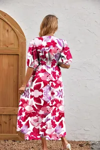 Back view of a woman wearing a fashion floral print maxi dress with puff sleeves.