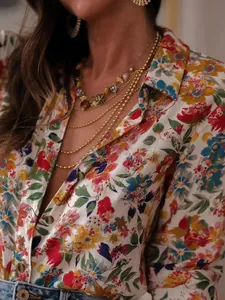 Close-up of vibrant floral print on women's long-sleeved collared holiday shirt