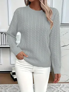 Detailed view of elegant grey cable-knit round-neck sweater worn by a fashion model