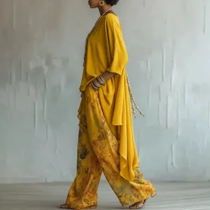 Elegant yellow two-piece set with long tunic top and floral print wide-leg trousers