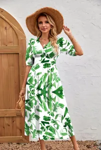 Detailed view of fashion printed V-neck women's dress with green floral pattern