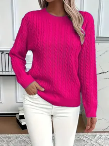 Close-up detail of a bright fuchsia cable knit crewneck sweater with thick texture