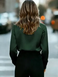 Elegant dark green glossy satin long sleeve shirt for women shown from the back