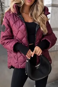 Close-up detail of women's burgundy diamond quilted hooded jacket for autumn winter