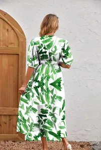 Back view of a white women's dress with vibrant green abstract brushstroke prints.