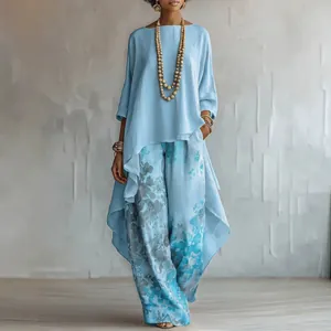 Elegant women's two-piece set featuring light blue asymmetrical top and floral wide-leg pants