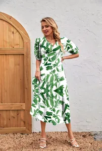 Detail view of a white women's midi dress with green abstract print and puff sleeves.