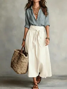 Boho style two-piece outfit with blue linen shirt and white tie-waist maxi skirt