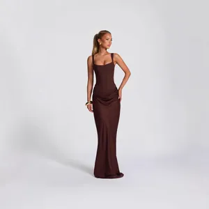 Elegant chocolate brown bodycon corset maxi dress with spaghetti straps and draped skirt detail.