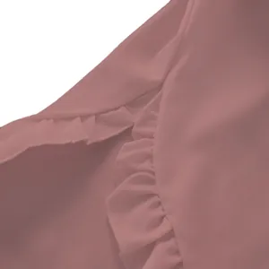 Macro detail showing the soft ruffles and delicate stitching on a pink shirt