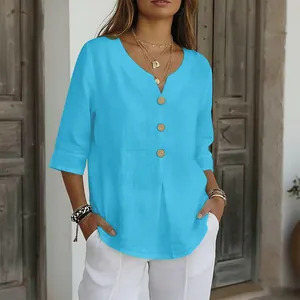 Dettaglio della camicetta blu da donna con scollo a V, bottoni in legno e mezze maniche
