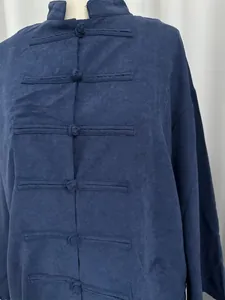 Close-up of navy blue Neo-Chinese shirt showing linen-like texture and frog buttons