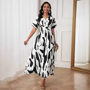 Elegant black and white abstract print V-neck dress with cinched waist and flowy skirt