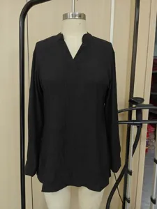 Detail view of a black V-neck long-sleeved casual shirt with lightweight textured fabric