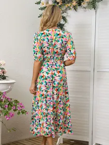 Back view of a vibrant floral print maxi dress with puff sleeves and elastic waist.