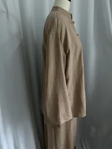 Side view of tan linen-like asymmetric long sleeve shirt and skirt two-piece set
