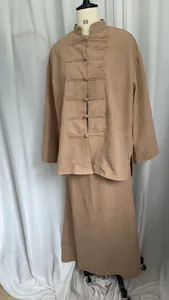 Detailed view of traditional Chinese style long-sleeved top and skirt set in tan