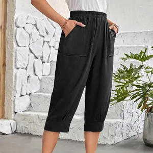 Detail of women's black cotton linen capri pants featuring elastic waist and large pockets