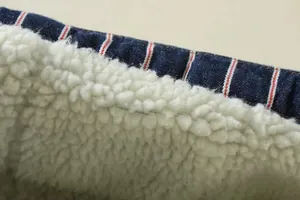 Detailed macro view of the warm white sherpa lining and striped denim outer fabric.