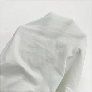Detailed macro view showing the breathable texture of white cotton-linen fabric for pants