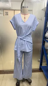 Light blue two-piece casual set featuring V-neck belted top and wide-leg trousers on dummy
