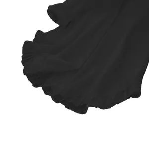 Close-up detail of the elegant ruffle hem on this black long-sleeve casual shirt