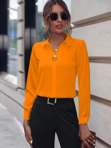 Detalle de la blusa naranja de manga larga para mujer con elegante cuello en V