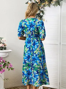 Stunning back view of a vibrant blue floral print maxi dress featuring an elasticated waist