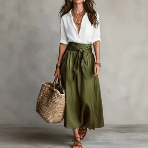 Stylish bohemian summer set featuring white button-up shirt and olive green maxi skirt