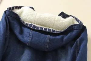 Detailed macro shot of blue denim hooded jacket featuring warm white faux shearling lining