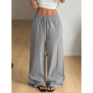 Detail view of grey loose wide-leg linen pants with adjustable drawstring waist