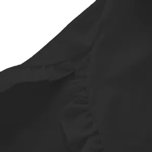 Close-up of delicate ruffle details on elegant black casual blouse fabric
